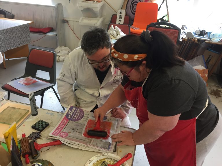 Image from Headway Arts' Printable Project showing participants printing using a hand roller